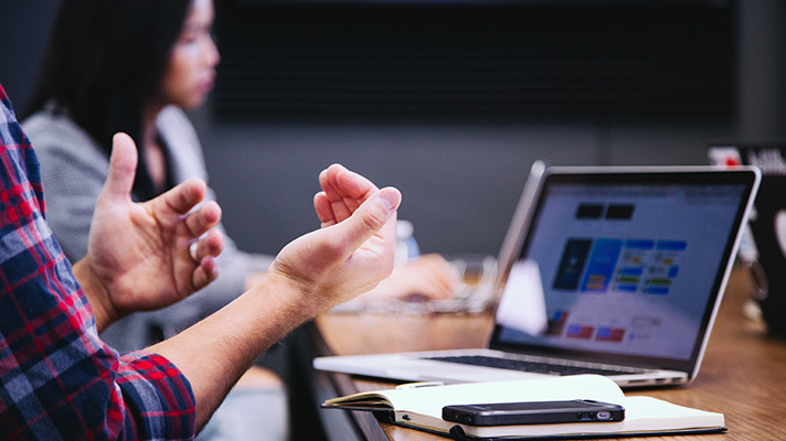 A stock photo of a Board meeting on a laptop