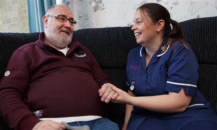 A photo of someone receiving home care by a hospice nurse