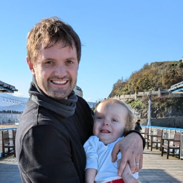 man holding son