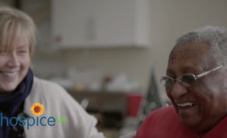 Two women laughing in a hospice setting