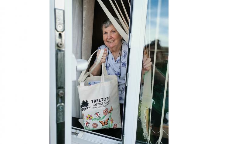 Woman with cake delivery from hospice