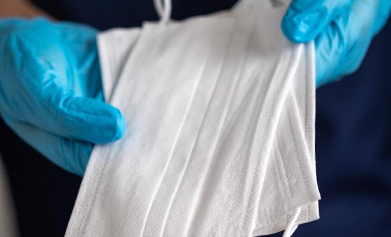 Care worker holding multiple disposable masks