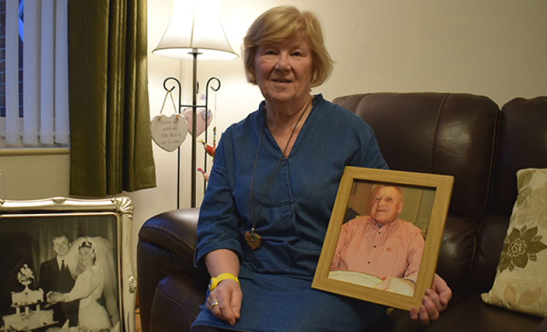 Margaret, holding a picture of her husband Gordon