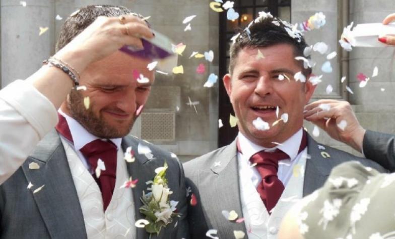 Gay couple getting married with confetti celebration 