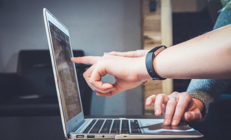 pointing at computer screen stock image