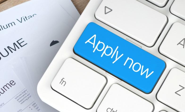 Stock photo of a keyboard with the shift key replaced with a blue Apply now button