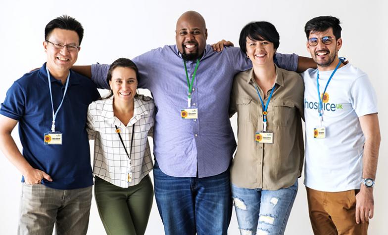 A group of people with Hospice UK clothing and badges