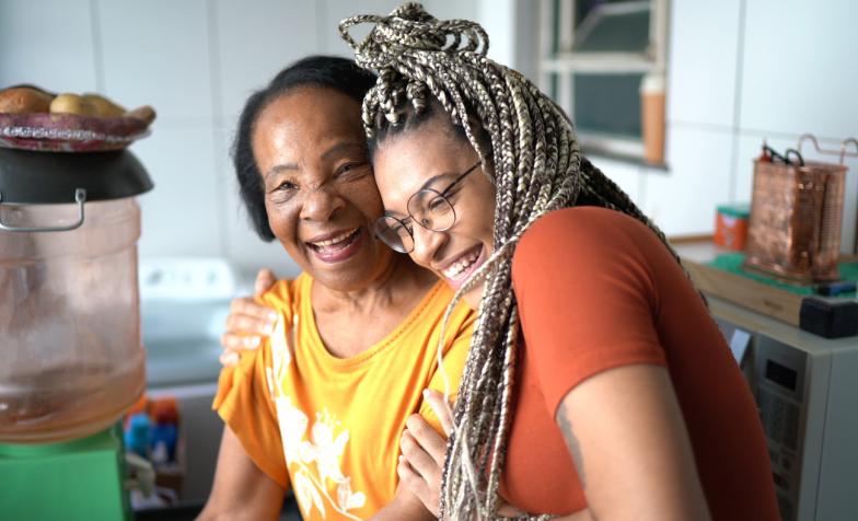 Grandmother and grandaughter hugging at home