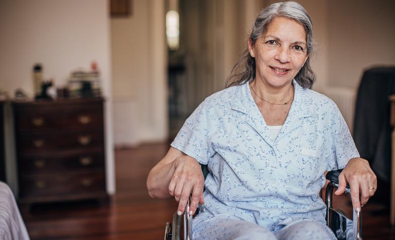 Women in wheelchair smiling at the camera