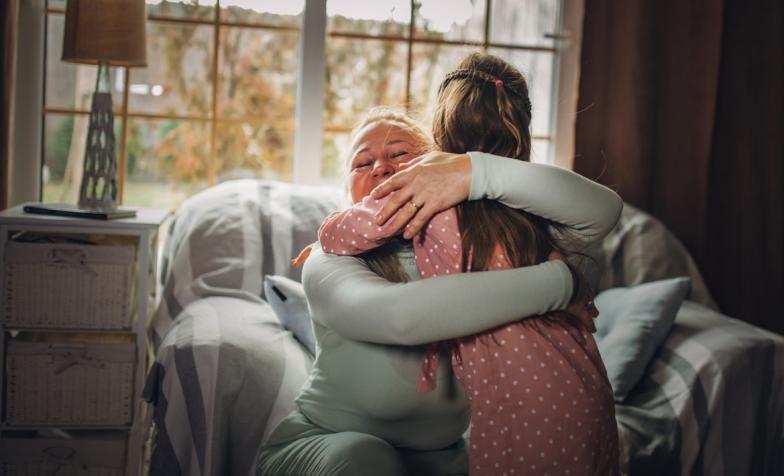 Woman hugging her granddaughter