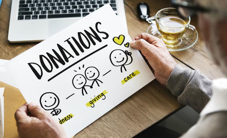 A stock image of someone looking at a sheet promoting donations