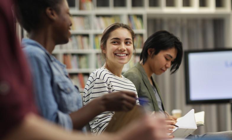 Young people smiling at an event