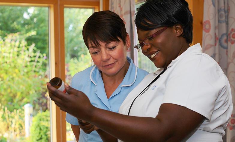 Two hospice nurses working in a hospice