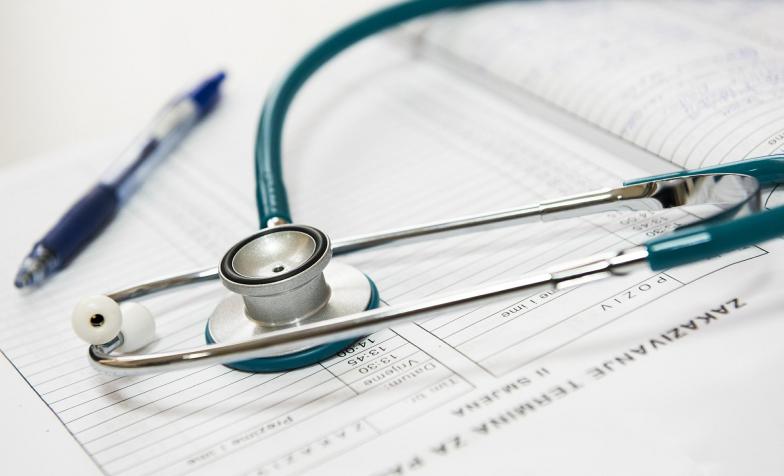 A stock photo of a stethoscope with clinical paperwork