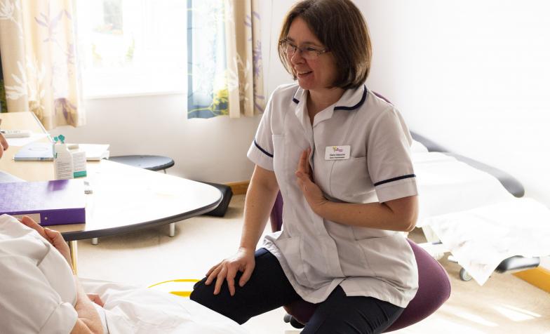 Allied health professional demonstrates breathing technique to a patient