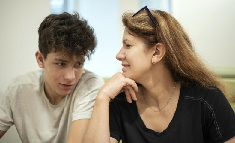 A woman looks at her son