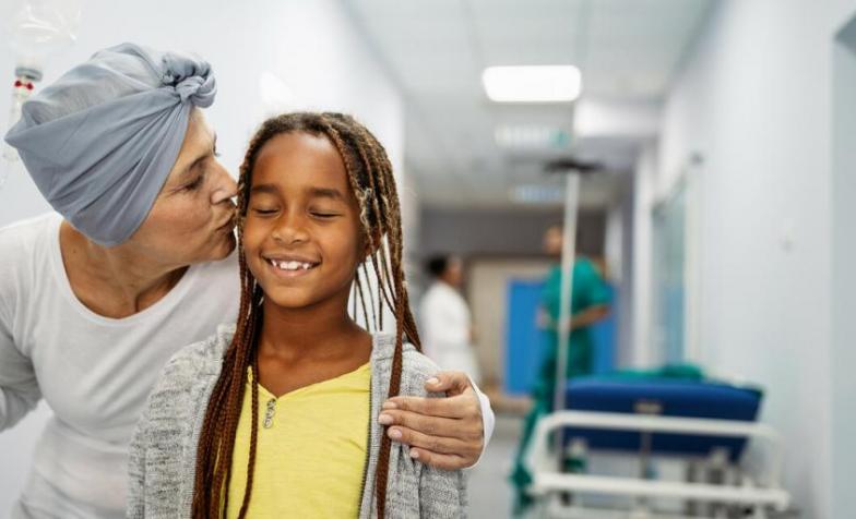 What to expect when someone is in the last few days of life. Woman in hospital kissing a young girl