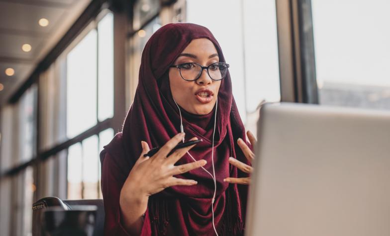 Stock photo of a woman having a conversation via her laptop