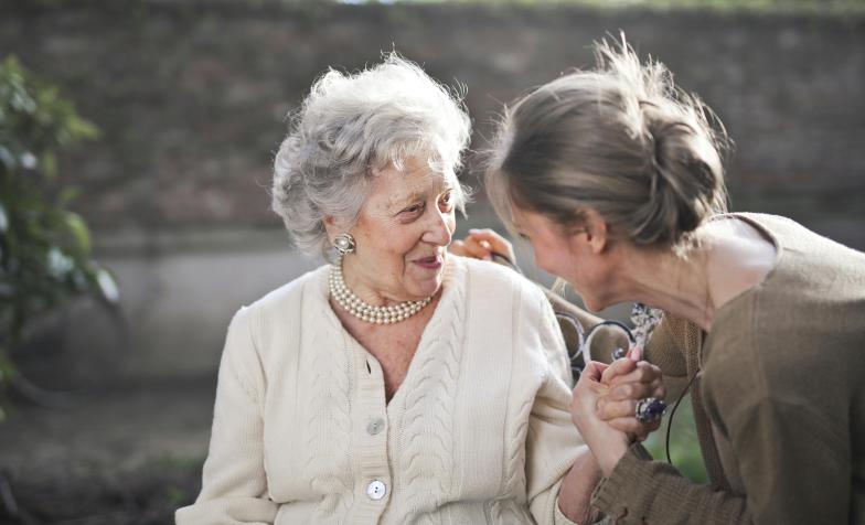 young woman looking at elderly woman