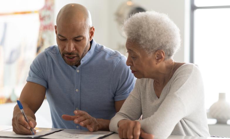 What to do when someone dies - an older woman with son writing a will