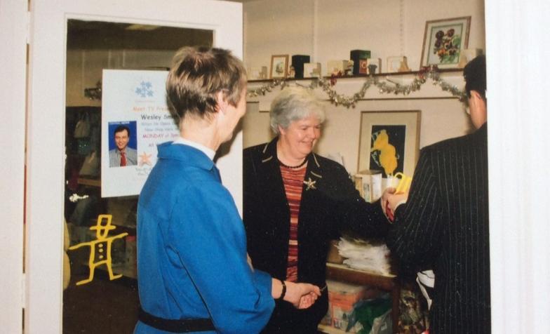 A snapshot from the past of a lady working in a charity shop