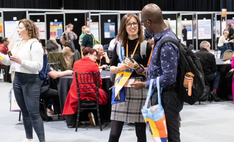 Two people talking in a conference exhibition space