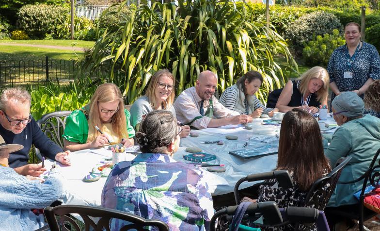 Patients at St Christopher’s Hospice get together to paint ‘Together Pebbles’ for the Hospice UK Garden of Compassion at RHS Chelsea Flower Show 2025 – with the help of comedian Tom Allen