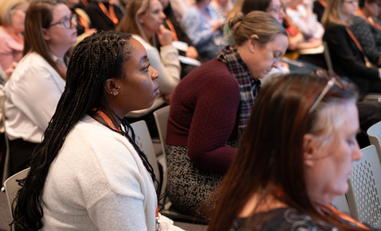 Close-up of people listening in a session at National Conference