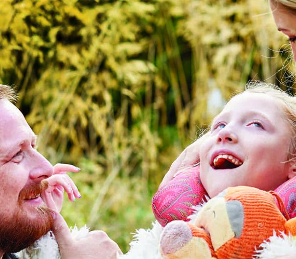 A photo of two parents and their child, who is receiving hospice care