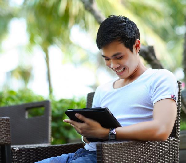 A stock photo from Pixabay of a man looking at a tablet screen