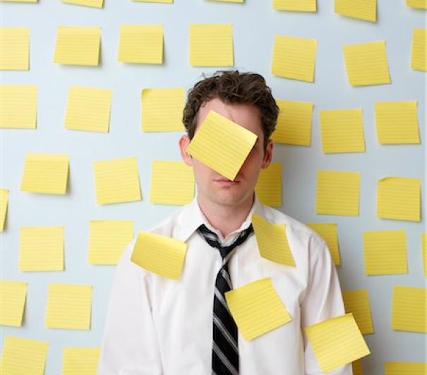 A stock photo of someone with a lot of post-it notes
