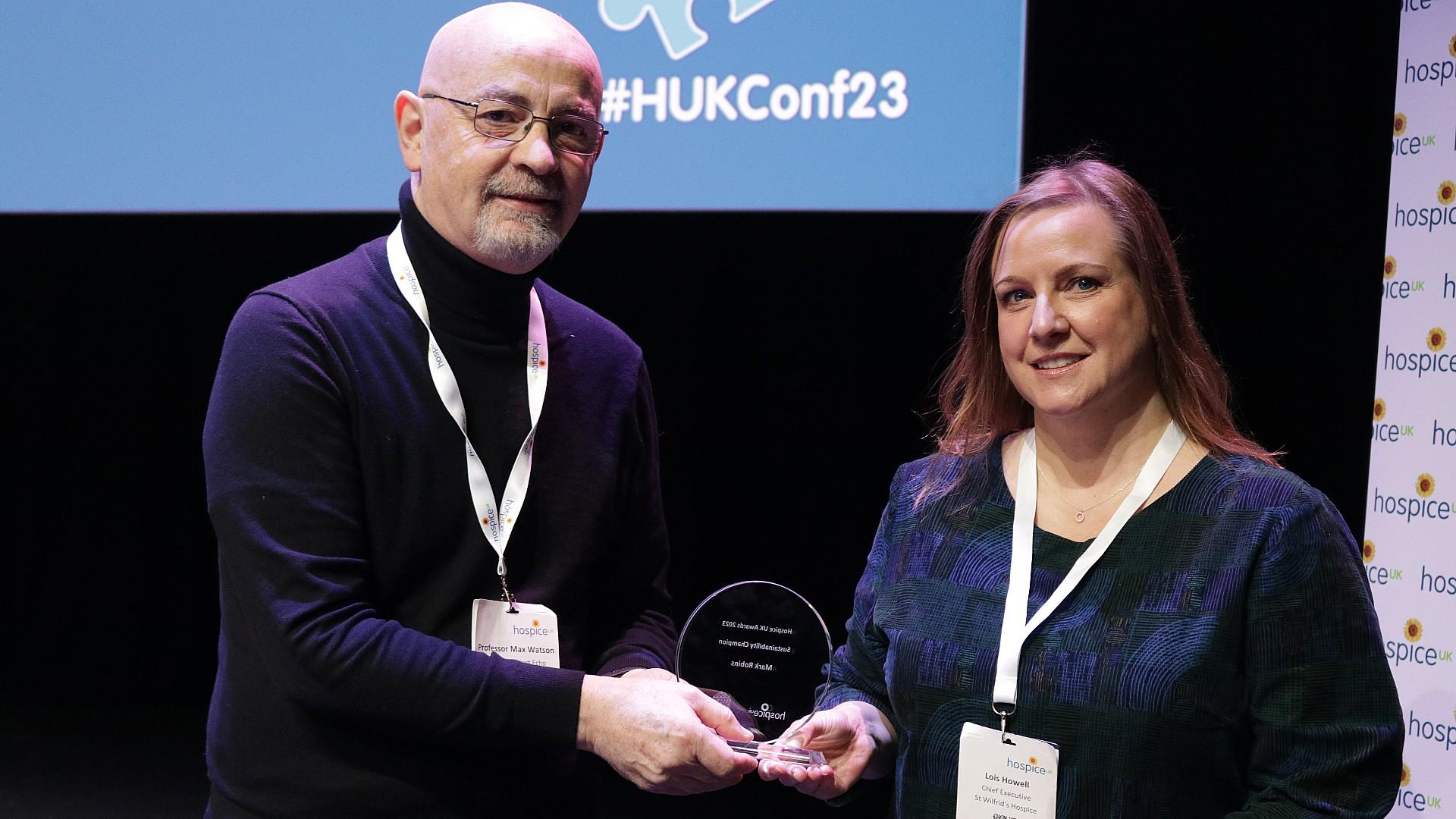 CEO of St Wilfrid's Hospice, Lois Howell, collects the Sustainability Champion award on behalf of Mark Robins
