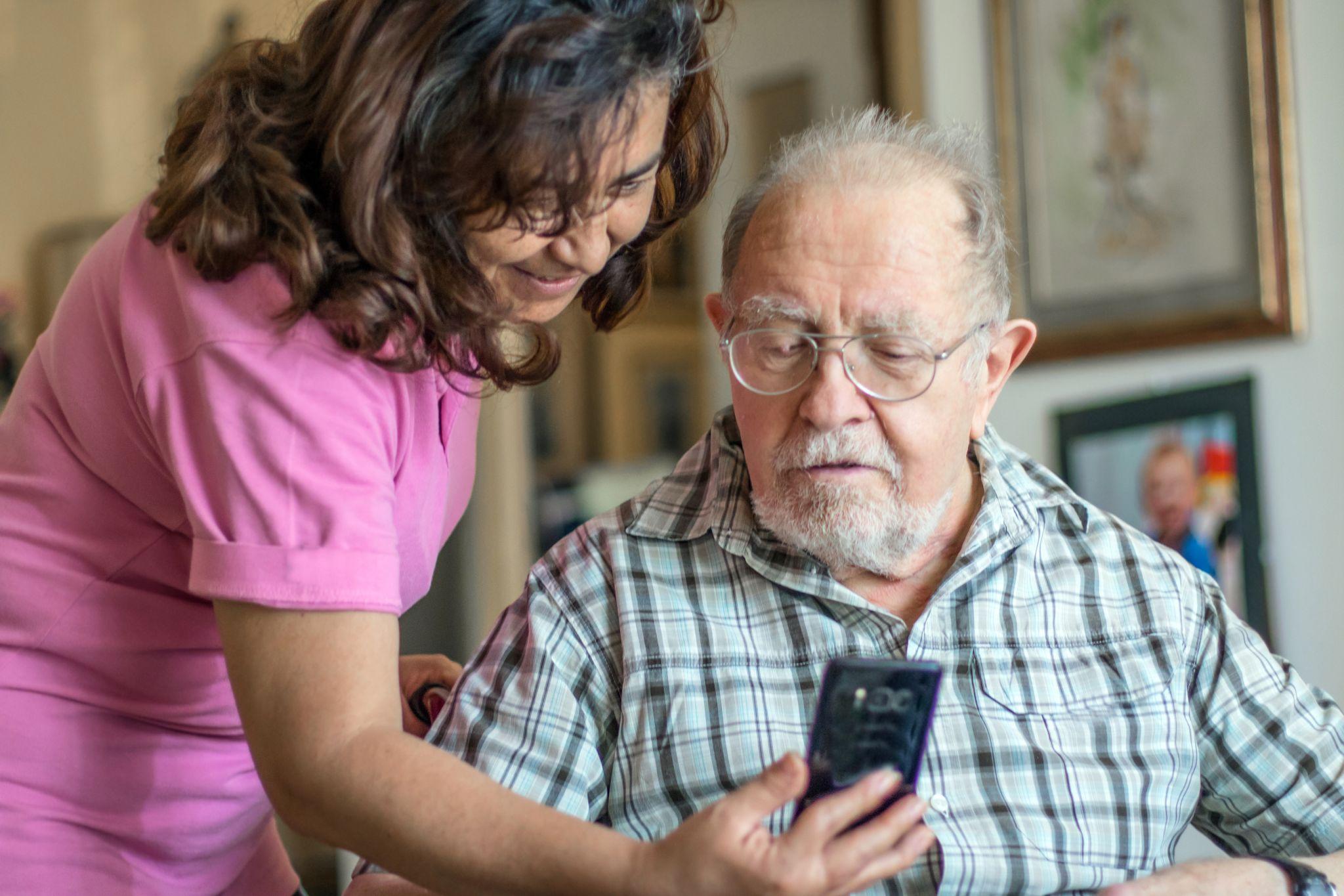 man with woman being shown phone