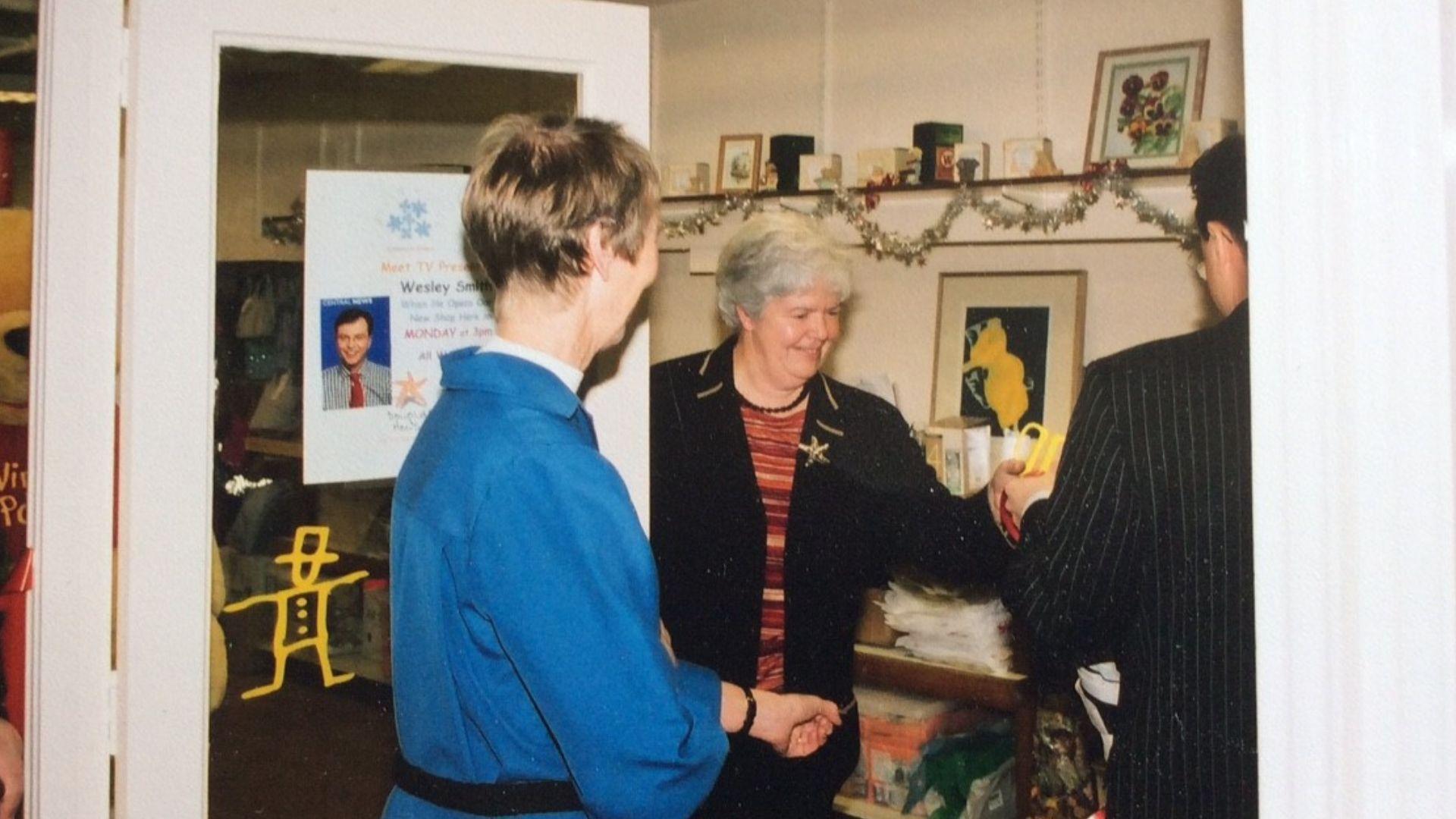 A snapshot from the past of a lady working in a charity shop