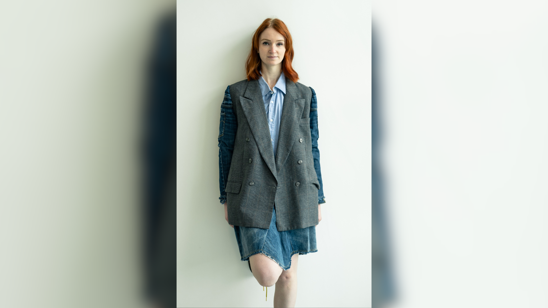 A woman wearing a blazer posing for the camera