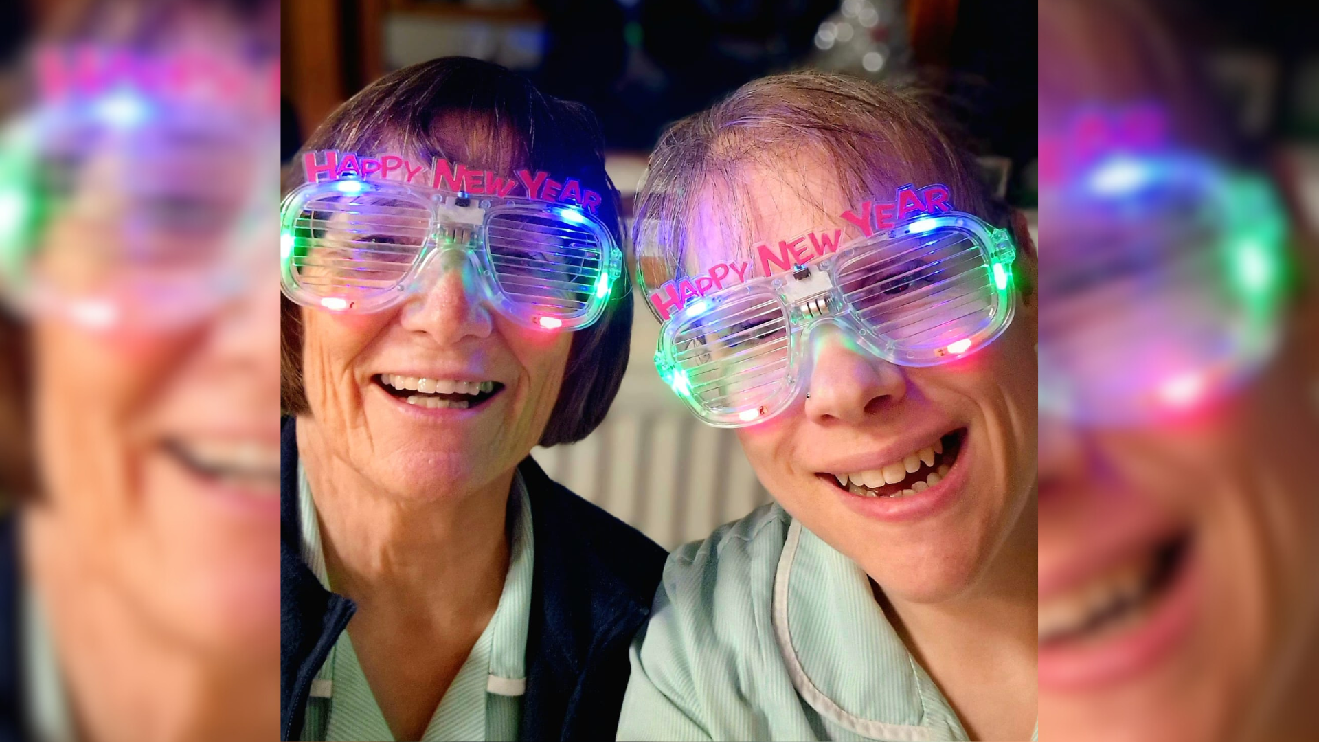 Two hospice nurses wearing light up NYE glasses