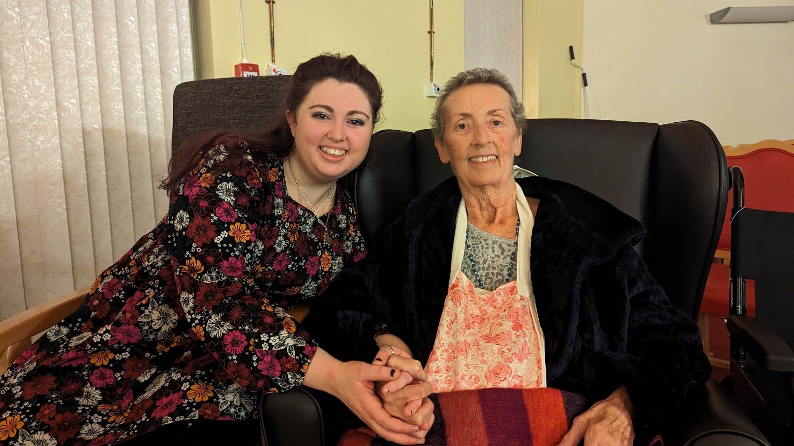 Two women holding hands and smilng
