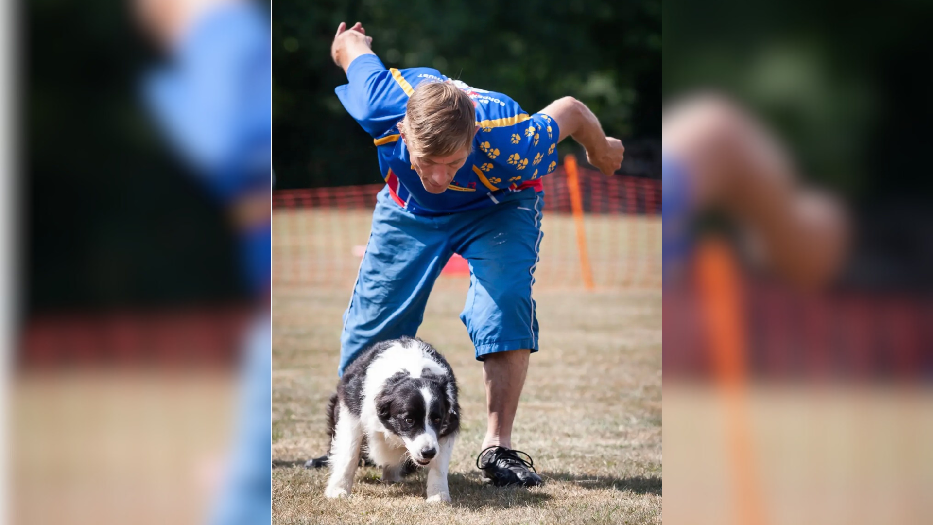 A man crouched over a dog