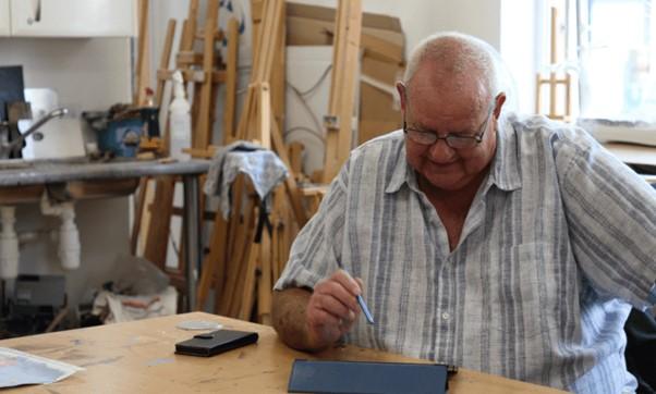 A man looking down at his desk