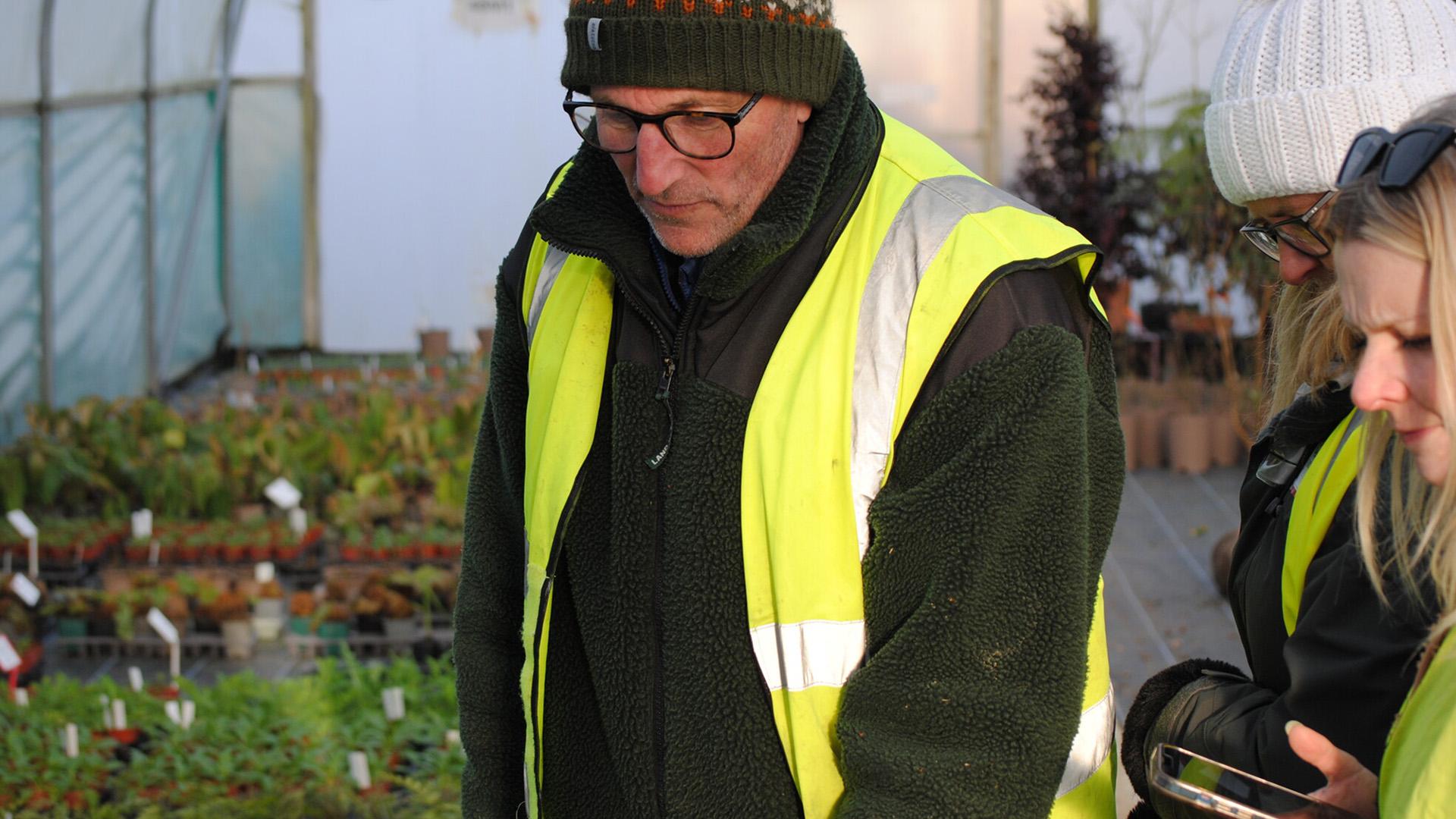 Tom Hoblyn showing Hospice UK staff around the nursery, where he is growing the thousands of plants for the Garden of Compassion at RHS Chelsea 2025