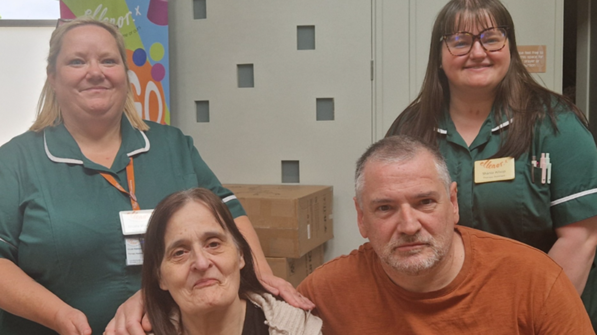 A patient with Alzheimer's with her husband and staff at ellenor