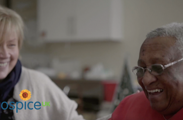 Two women laughing in a hospice setting
