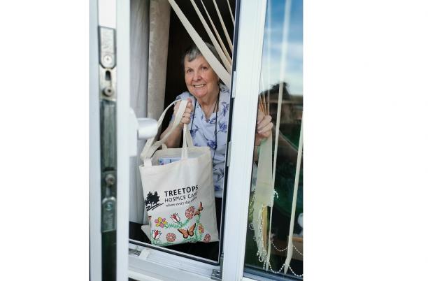 Woman with cake delivery from hospice