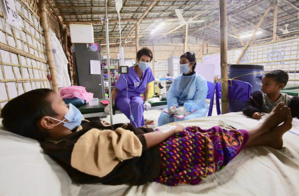 Palliative care workers attending to a patient
