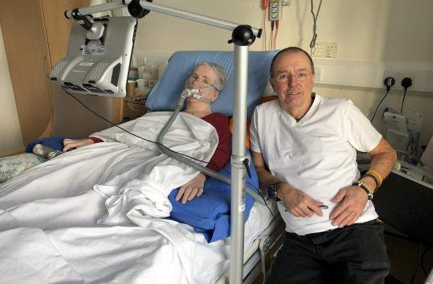 Female patient in hospital bed with husband