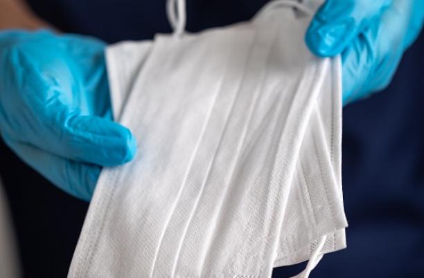 Care worker holding multiple disposable masks