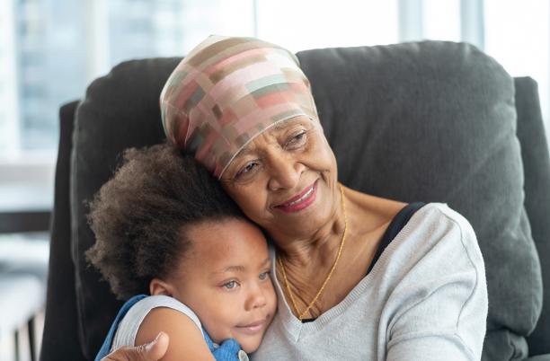 Grandmother holds her young granddaughter