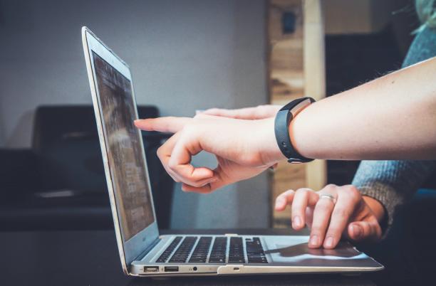 pointing at computer screen stock image
