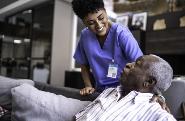 Female nurse taking care of a senior man