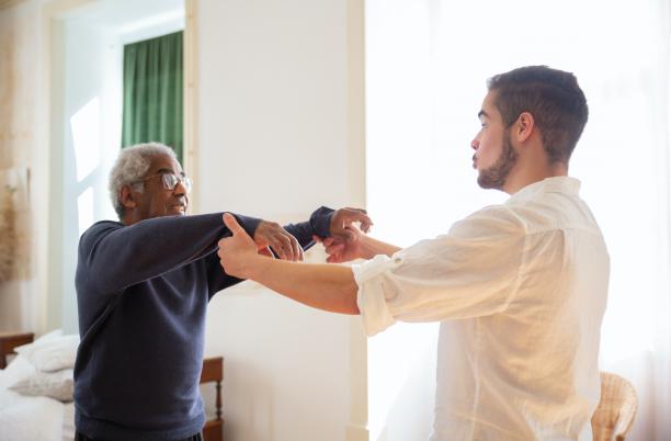 Elderly man dancing with younger man